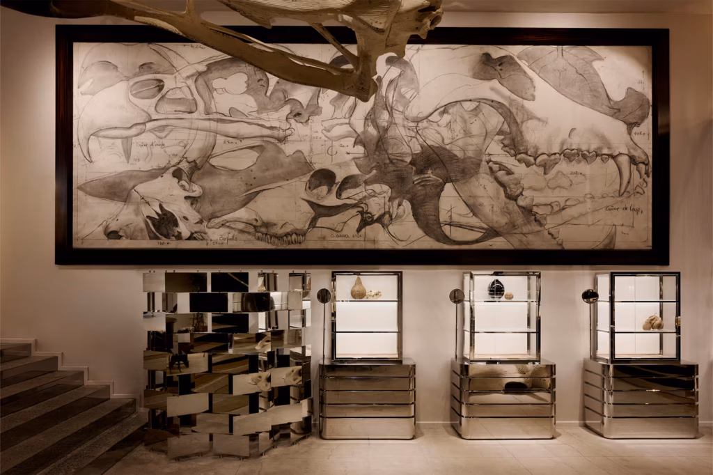 A museum display features fossil specimens in glass cases, mirrored pedestals, and a large black-and-white dinosaur fossil illustration on the wall. Part of a dinosaur skeleton hangs from the ceiling.